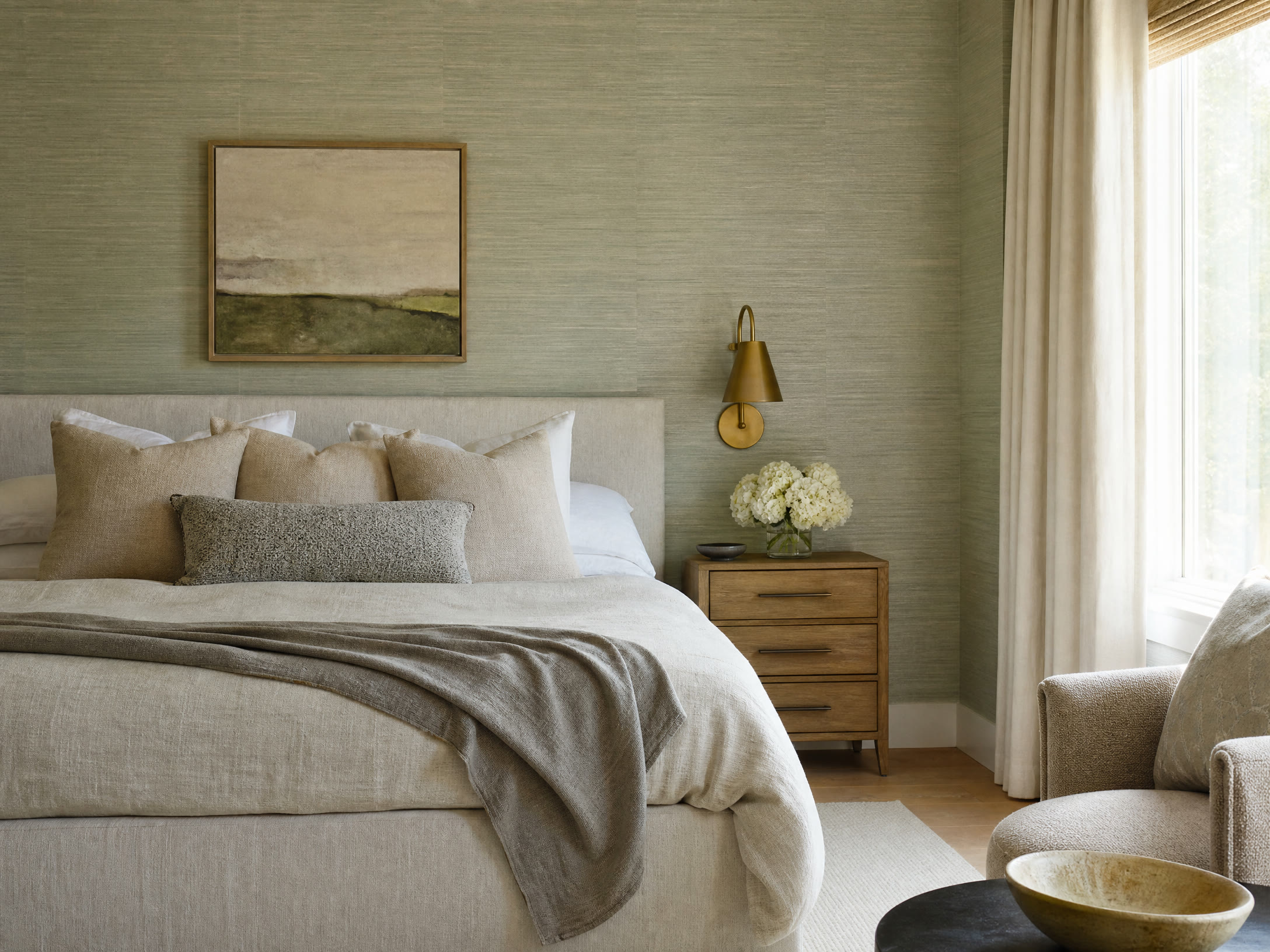 Serene bedroom with sage grasscloth wallpaper and tailored natural textures