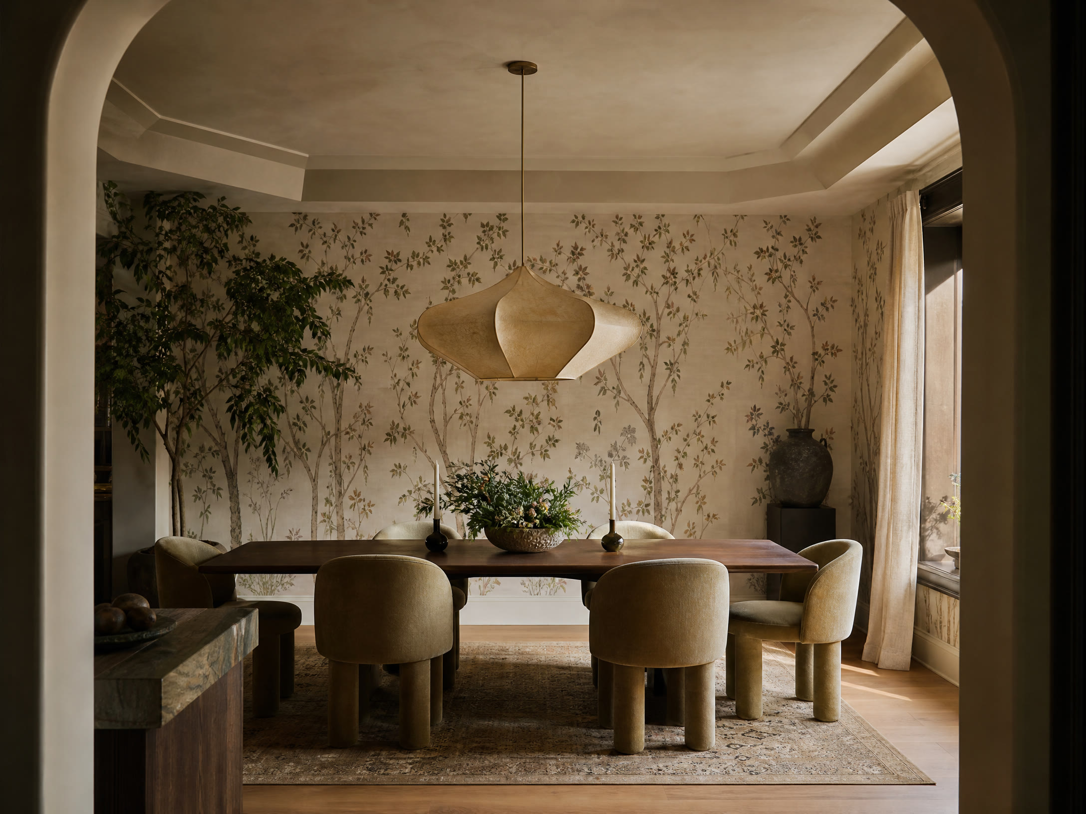Dining room with botanical wallpaper, dark walnut table and sculptural pendant